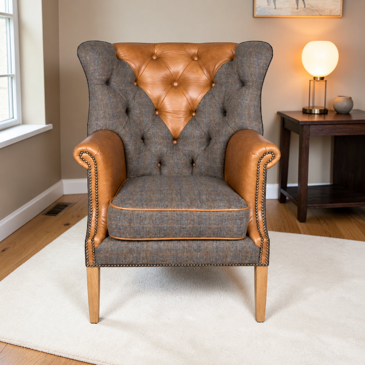 A classic wingback armchair with a Uist Harris Tweed body and Cerato tan leather panels on the backrest and armrests, styled in a cosy living room setting.