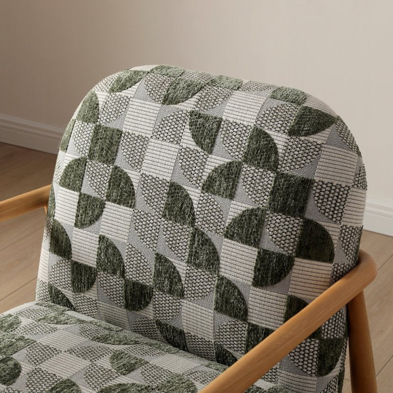 Chair with a patterned green and gray cushion on a wooden floor.