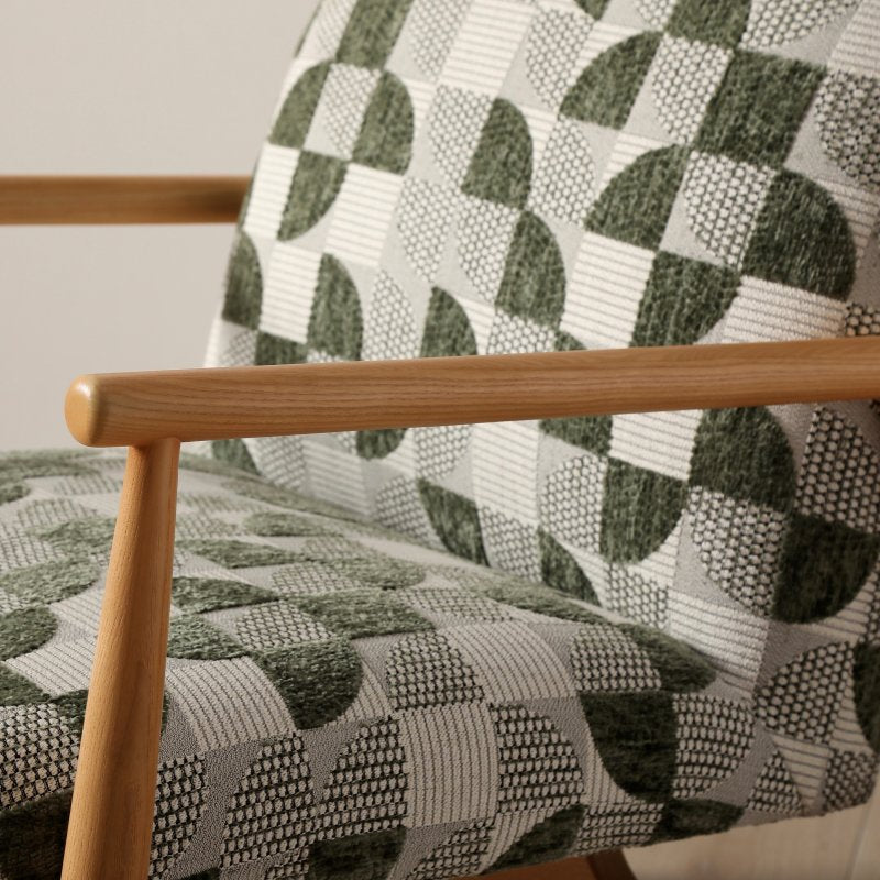 Close up of the green geometric jacquard upholstery