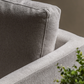 Close-up of Henley armrest and back cushion upholstered in Natural fabric with a blurred background