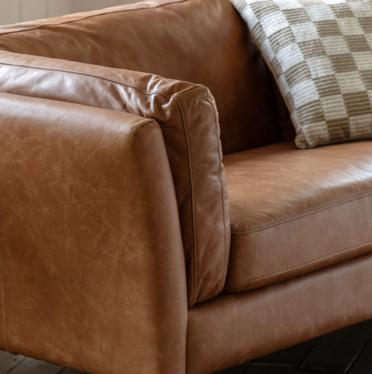 Close-up of Hampton mellow brown leather sofa showing the padded arm and natural leather texture