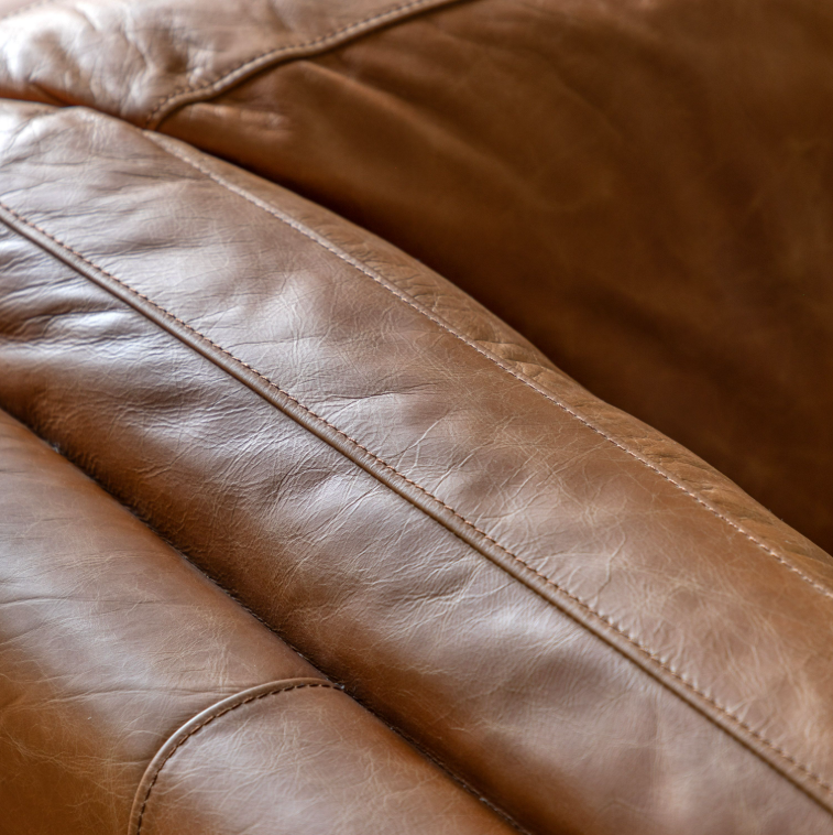 Close-up of Hampton sofa showing the mellow brown top-grain leather and cushioned upholstery