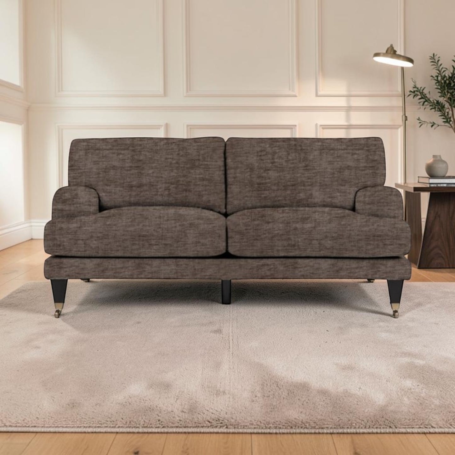 A sofa upholstered in textured brown fabric, positioned on a light beige area rug in a modern living room setting with wood paneling and a side table.