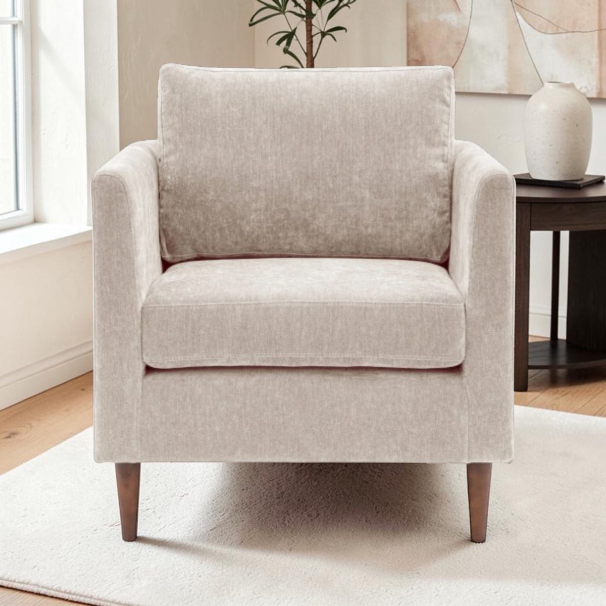 Henley Armchair in Natural fabric with deep cushioning, tapered arms and turned wooden legs