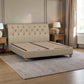 A beige upholstered bed frame with a tall tufted headboard and wooden legs, shown in a styled bedroom setting with wooden nightstands, lamps, a window, and a gray rug.